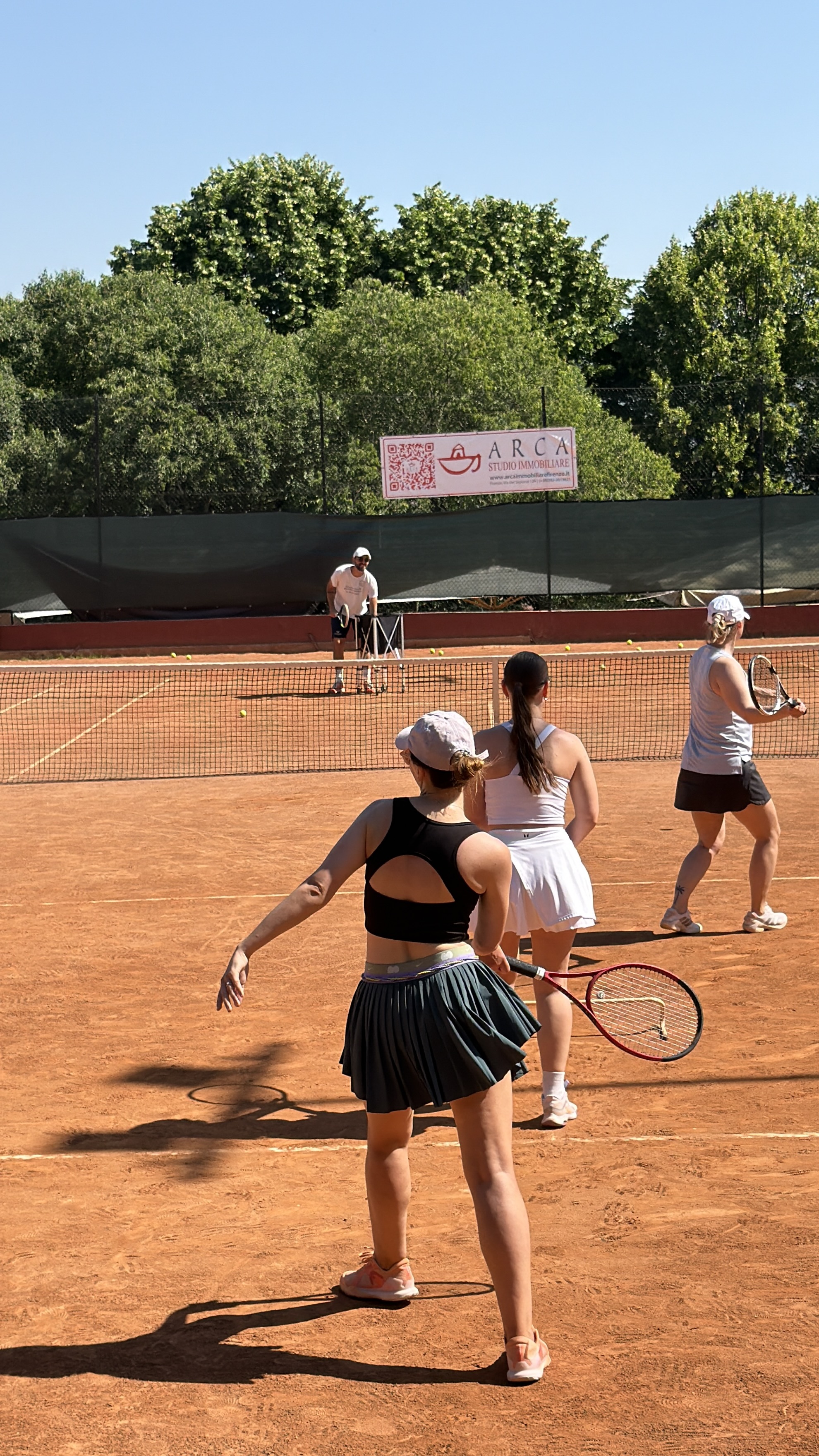 Group tennis training on clay court